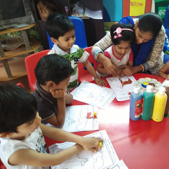 Children colouring at the activity table
